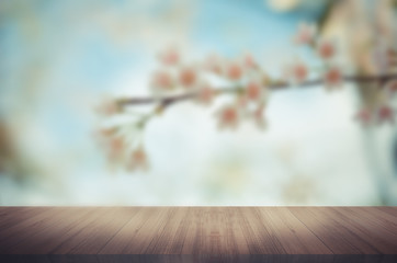 Naklejka na ściany i meble Wood table top on blurred Flower background