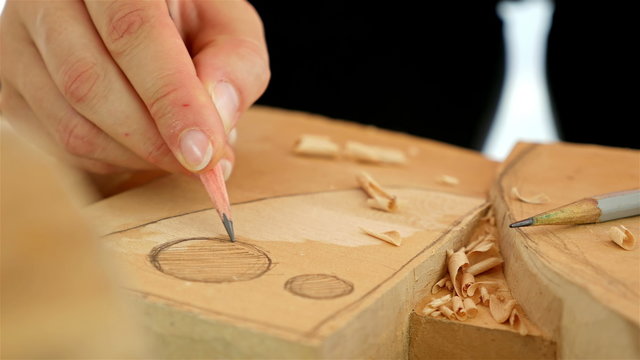 Wood carving - Human hand drawing over a piece of wood