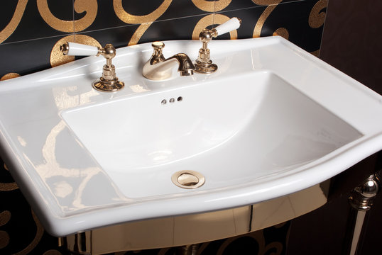 White Bathroom Sink On The Decorated Black Wall