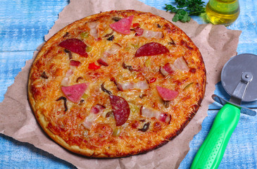 close-up Delicious Meat Pizza with Ham, Bacon and sausages on the wooden background