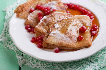 Fresh homemade crepes on plate with fresh berries