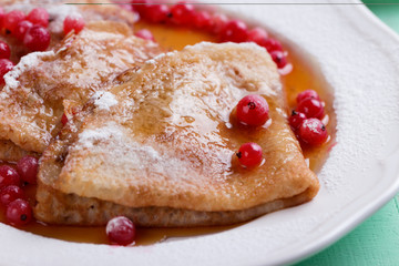 Fresh homemade crepes on plate with fresh berries