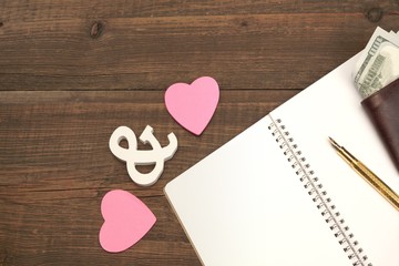 Wedding Costs Concept. Hearts, Pen, Paper, Money On Wood Backgro