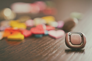 buttons lie on the wooden oak table. Stylized picture with an ol