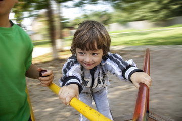happy boy on carousel outdoors