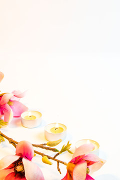 Spa flowers and candles on white background