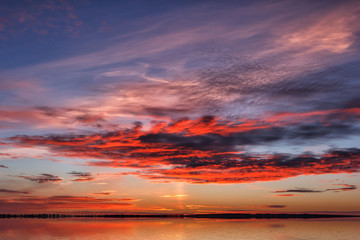 Fototapeta premium Beautiful sky sunset. Twilight dramatic red clouds