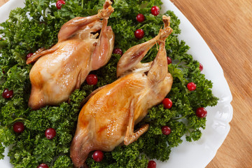 Carcasses of quail roasted with cranberry and parsley