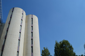 Fototapeta premium Tall white modern university building with small windows