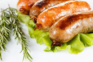 Roast beef or chicken sausage on a plate