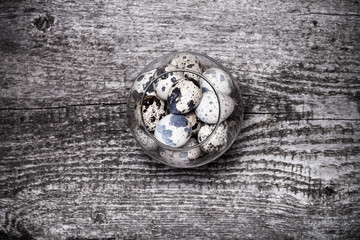 Composition with quail eggs. Wooden texture for background. Tone