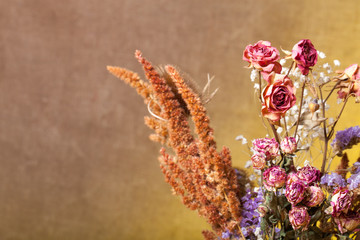 Bouquet of dry flowers on burlap background. Selective focus