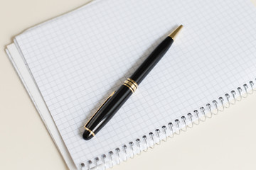 black pen with white pad or notepad