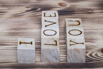 Wooden cubes with inscription "I LOVE YOU" on new wooden backgro