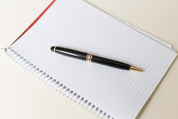 black pen with white pad or notepad