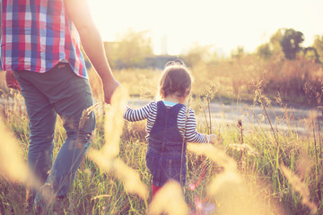 Toddler girl playing with daddy in the garden © rastlily