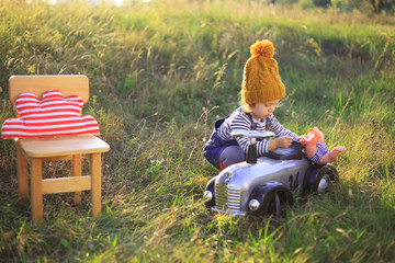 Kid have fun with toy car outdoors