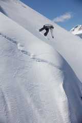 Flying snowboarder on mountains. Extreme sport.