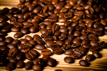 Coffee beans on wooden table for background. Selective focus. To