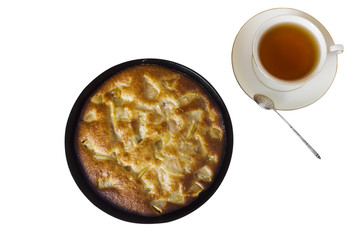 Charlotte. Apple pie with a cup of black tea on a white backgrou