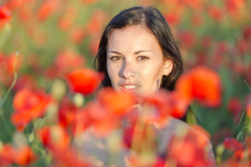 Young woman in poppy field