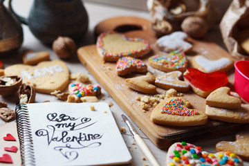 Desk with Valentines cookies with notepad