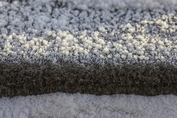 Crystals of frost on the surface granite stone