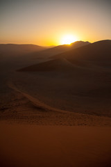 Fototapeta na wymiar Sunrise above dunes in Namib Desert, Namibia
