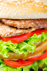 Delicious hamburger and french fries on wooden table