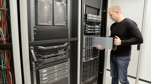 IT consultant removes blade server in datacenter