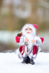 Model of Santa Claus standing in white snow outdoors