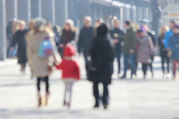 Blurred photo of  unrecognizable person who walking along city street