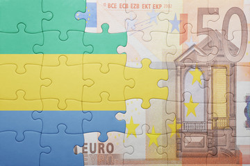 puzzle with the national flag of gabon and euro banknote
