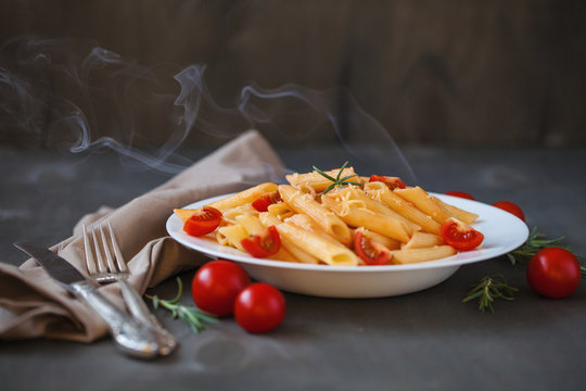 Pasta in tomato sauce on a wooden table