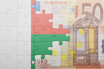 puzzle with the national flag of madagascar and euro banknote