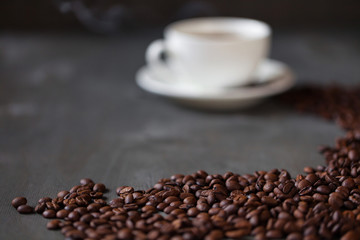 Coffee cup and saucer on a wooden table. Grey background