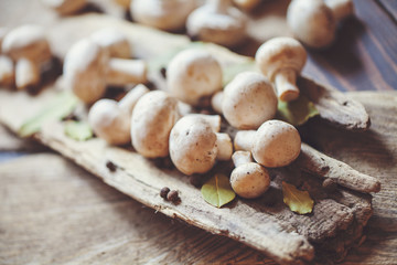 Fresh champignon mushrooms on a rustic wooden counter ready to be cleaned and washed for dinner