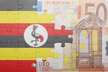 puzzle with the national flag of uganda and euro banknote