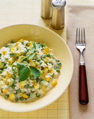 Italian food. Risotto with peas,squash and avocado.