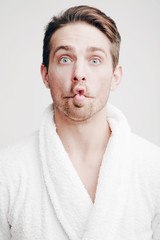 Emotions. Portrait of a young man in a bathrobe