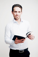 Young attractive man with a book