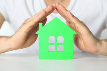 Male hands and house, closeup