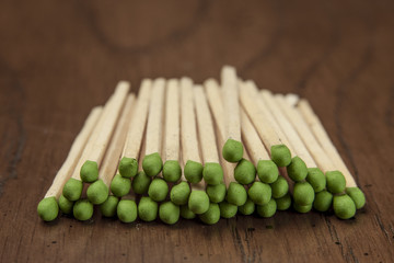 Stacked green tipped matches.