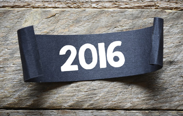 paper sheet with 2016 year sign on wooden background