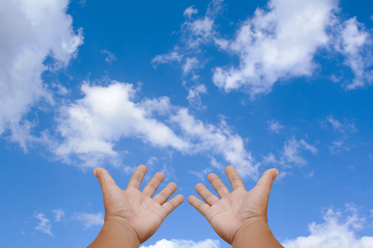 Human hands blue sky background