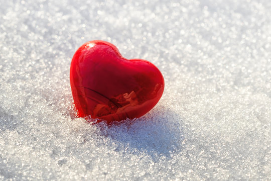 red heart on ice wet snow, selective focus, outdoors image