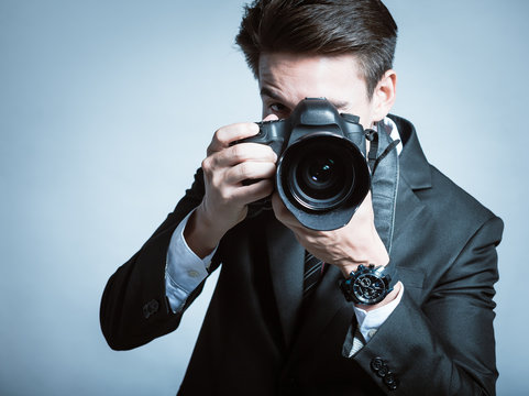 Young man using a professional camera
