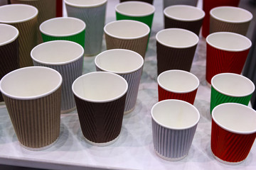 Multicolored empty disposable cups are on the table