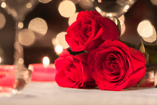 Closeup of beautiful roses in a fine dinning setting.
