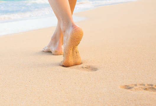 Feet walking in the sand. 